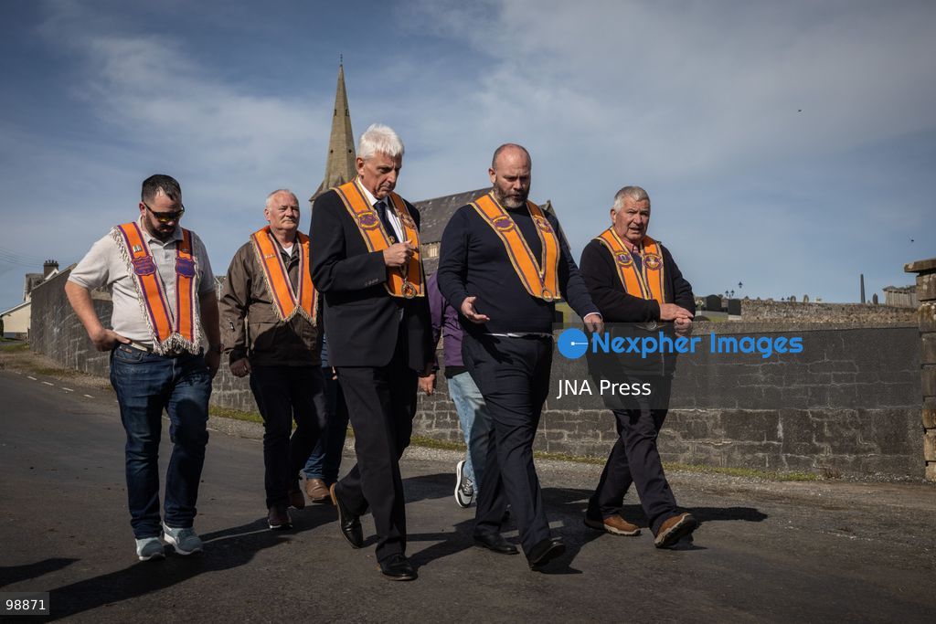 PORTADOWN, NORTHERN IRELAND, SEPTEMBER 28, 2026: Members of the Orange Order gather near Drumcree Parish Church as a standoff over the contentious Drumcree parade continues in Portadown. The Protestant fraternal organization had been granted conditional permission to march along the predominantly nationalist Garvaghy Road for the first time in nearly three decades, but the route was blocked by thousands of protesters and police prevented the parade from proceeding amid public safety concerns. On Monday, residents continued gathering on Garvaghy Road while Orange Order members remained near Drumcree Church as discussions continued with police and officials over the dispute. Photo by Nadia Caimi / JNA Press. (Photo by Nadia Caimi/JNA Press via Nexpher Images)