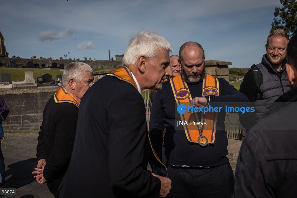 PORTADOWN, NORTHERN IRELAND, SEPTEMBER 28, 2026: Members of the Orange Order gather near Drumcree Parish Church as a standoff over the contentious Drumcree parade continues in Portadown. The Protestant fraternal organization had been granted conditional permission to march along the predominantly nationalist Garvaghy Road for the first time in nearly three decades, but the route was blocked by thousands of protesters and police prevented the parade from proceeding amid public safety concerns. On Monday, residents continued gathering on Garvaghy Road while Orange Order members remained near Drumcree Church as discussions continued with police and officials over the dispute. Photo by Nadia Caimi / JNA Press. (Photo by Nadia Caimi/JNA Press via Nexpher Images)