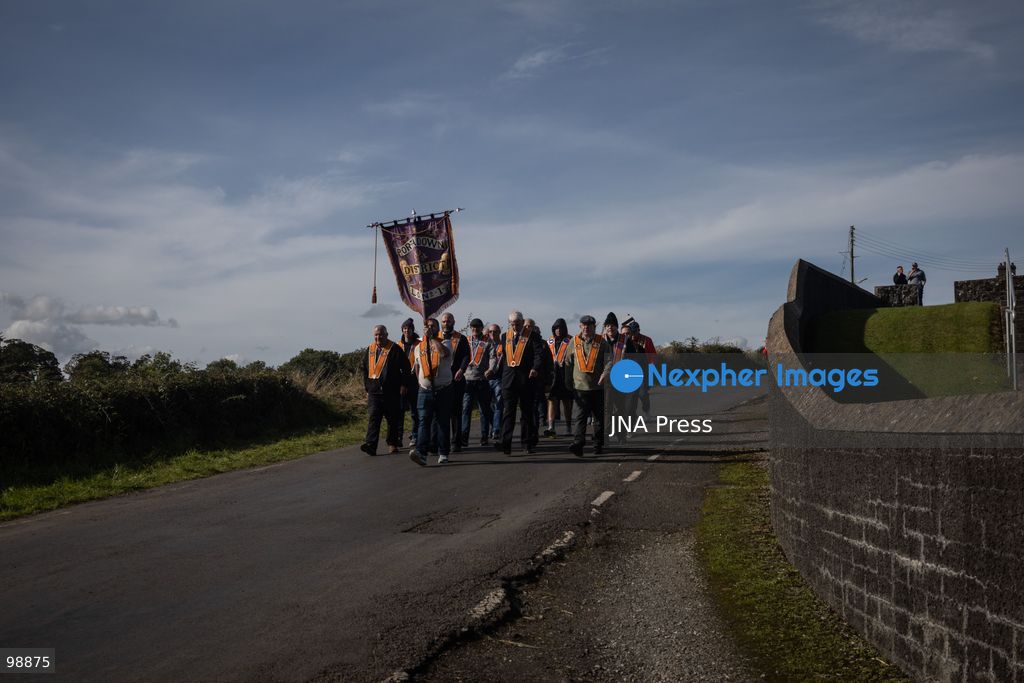 PORTADOWN, NORTHERN IRELAND, SEPTEMBER 28, 2026: Members of the Orange Order gather near Drumcree Parish Church as a standoff over the contentious Drumcree parade continues in Portadown. The Protestant fraternal organization had been granted conditional permission to march along the predominantly nationalist Garvaghy Road for the first time in nearly three decades, but the route was blocked by thousands of protesters and police prevented the parade from proceeding amid public safety concerns. On Monday, residents continued gathering on Garvaghy Road while Orange Order members remained near Drumcree Church as discussions continued with police and officials over the dispute. Photo by Nadia Caimi / JNA Press. (Photo by Nadia Caimi/JNA Press via Nexpher Images)