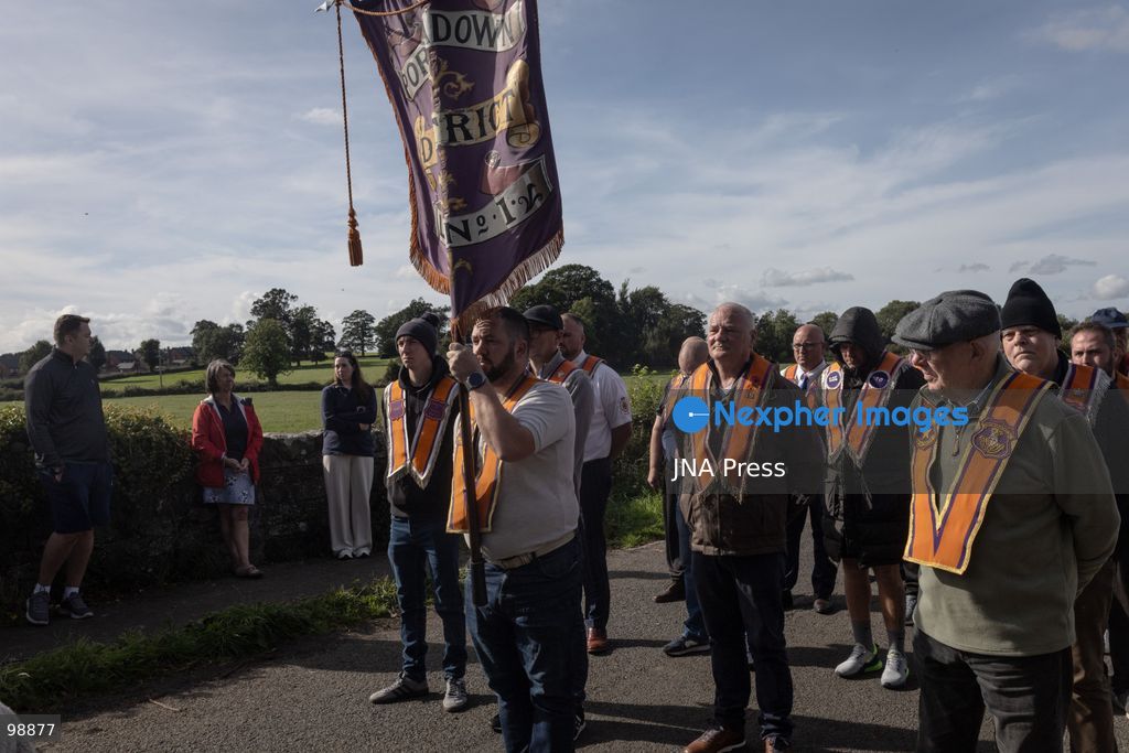 PORTADOWN, NORTHERN IRELAND, SEPTEMBER 28, 2026: Members of the Orange Order gather near Drumcree Parish Church as a standoff over the contentious Drumcree parade continues in Portadown. The Protestant fraternal organization had been granted conditional permission to march along the predominantly nationalist Garvaghy Road for the first time in nearly three decades, but the route was blocked by thousands of protesters and police prevented the parade from proceeding amid public safety concerns. On Monday, residents continued gathering on Garvaghy Road while Orange Order members remained near Drumcree Church as discussions continued with police and officials over the dispute. Photo by Nadia Caimi / JNA Press. (Photo by Nadia Caimi/JNA Press via Nexpher Images)