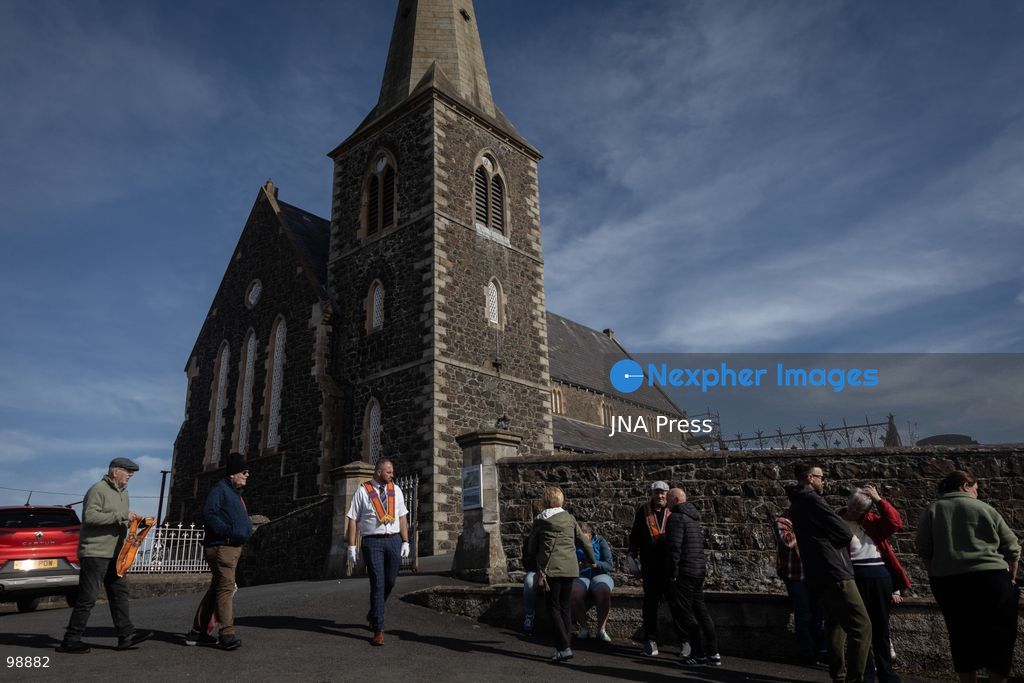 PORTADOWN, NORTHERN IRELAND, SEPTEMBER 28, 2026: Members of the Orange Order gather near Drumcree Parish Church as a standoff over the contentious Drumcree parade continues in Portadown. The Protestant fraternal organization had been granted conditional permission to march along the predominantly nationalist Garvaghy Road for the first time in nearly three decades, but the route was blocked by thousands of protesters and police prevented the parade from proceeding amid public safety concerns. On Monday, residents continued gathering on Garvaghy Road while Orange Order members remained near Drumcree Church as discussions continued with police and officials over the dispute. Photo by Nadia Caimi / JNA Press. (Photo by Nadia Caimi/JNA Press via Nexpher Images)
