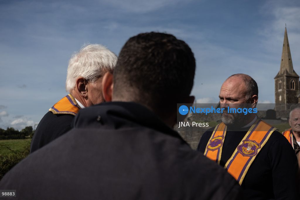 PORTADOWN, NORTHERN IRELAND, SEPTEMBER 28, 2026: Members of the Orange Order gather near Drumcree Parish Church as a standoff over the contentious Drumcree parade continues in Portadown. The Protestant fraternal organization had been granted conditional permission to march along the predominantly nationalist Garvaghy Road for the first time in nearly three decades, but the route was blocked by thousands of protesters and police prevented the parade from proceeding amid public safety concerns. On Monday, residents continued gathering on Garvaghy Road while Orange Order members remained near Drumcree Church as discussions continued with police and officials over the dispute. Photo by Nadia Caimi / JNA Press. (Photo by Nadia Caimi/JNA Press via Nexpher Images)
