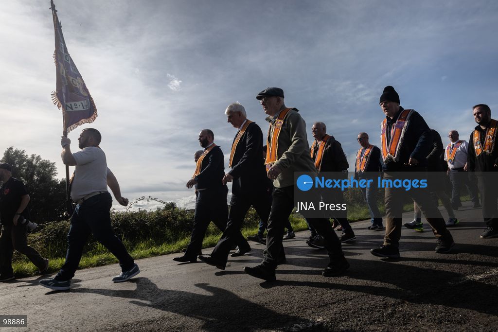 PORTADOWN, NORTHERN IRELAND, SEPTEMBER 28, 2026: Members of the Orange Order gather near Drumcree Parish Church as a standoff over the contentious Drumcree parade continues in Portadown. The Protestant fraternal organization had been granted conditional permission to march along the predominantly nationalist Garvaghy Road for the first time in nearly three decades, but the route was blocked by thousands of protesters and police prevented the parade from proceeding amid public safety concerns. On Monday, residents continued gathering on Garvaghy Road while Orange Order members remained near Drumcree Church as discussions continued with police and officials over the dispute. Photo by Nadia Caimi / JNA Press. (Photo by Nadia Caimi/JNA Press via Nexpher Images)