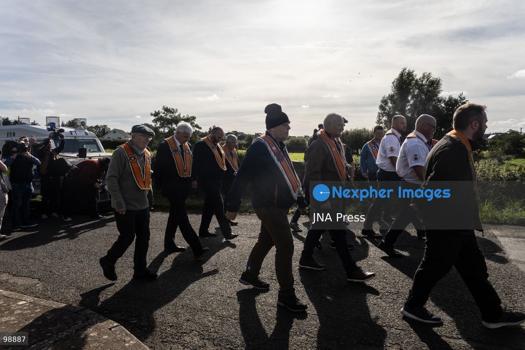 PORTADOWN, NORTHERN IRELAND, SEPTEMBER 28, 2026: Members of the Orange Order gather near Drumcree Parish Church as a standoff over the contentious Drumcree parade continues in Portadown. The Protestant fraternal organization had been granted conditional permission to march along the predominantly nationalist Garvaghy Road for the first time in nearly three decades, but the route was blocked by thousands of protesters and police prevented the parade from proceeding amid public safety concerns. On Monday, residents continued gathering on Garvaghy Road while Orange Order members remained near Drumcree Church as discussions continued with police and officials over the dispute. Photo by Nadia Caimi / JNA Press. (Photo by Nadia Caimi/JNA Press via Nexpher Images)
