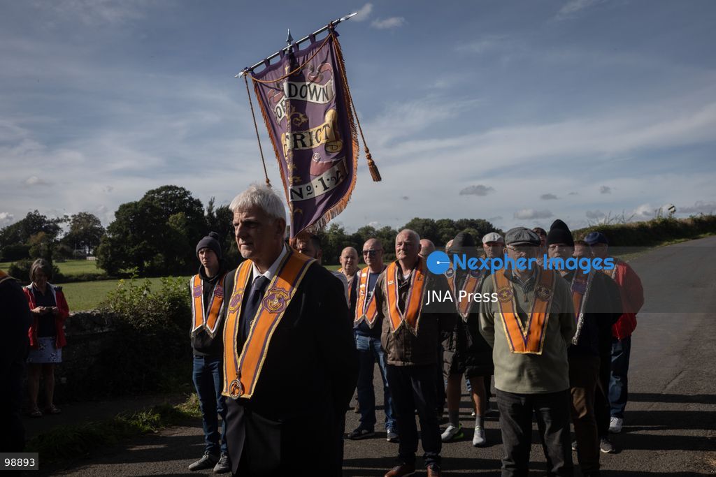 PORTADOWN, NORTHERN IRELAND, SEPTEMBER 28, 2026: Members of the Orange Order gather near Drumcree Parish Church as a standoff over the contentious Drumcree parade continues in Portadown. The Protestant fraternal organization had been granted conditional permission to march along the predominantly nationalist Garvaghy Road for the first time in nearly three decades, but the route was blocked by thousands of protesters and police prevented the parade from proceeding amid public safety concerns. On Monday, residents continued gathering on Garvaghy Road while Orange Order members remained near Drumcree Church as discussions continued with police and officials over the dispute. Photo by Nadia Caimi / JNA Press. (Photo by Nadia Caimi/JNA Press via Nexpher Images)