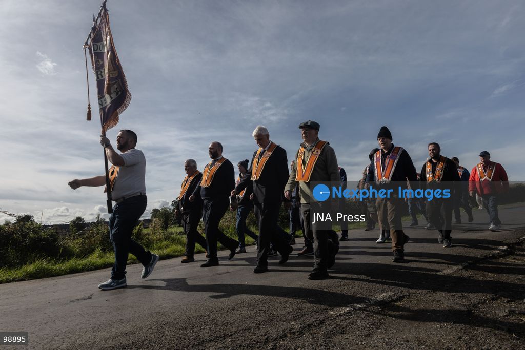 PORTADOWN, NORTHERN IRELAND, SEPTEMBER 28, 2026: Members of the Orange Order gather near Drumcree Parish Church as a standoff over the contentious Drumcree parade continues in Portadown. The Protestant fraternal organization had been granted conditional permission to march along the predominantly nationalist Garvaghy Road for the first time in nearly three decades, but the route was blocked by thousands of protesters and police prevented the parade from proceeding amid public safety concerns. On Monday, residents continued gathering on Garvaghy Road while Orange Order members remained near Drumcree Church as discussions continued with police and officials over the dispute. Photo by Nadia Caimi / JNA Press. (Photo by Nadia Caimi/JNA Press via Nexpher Images)