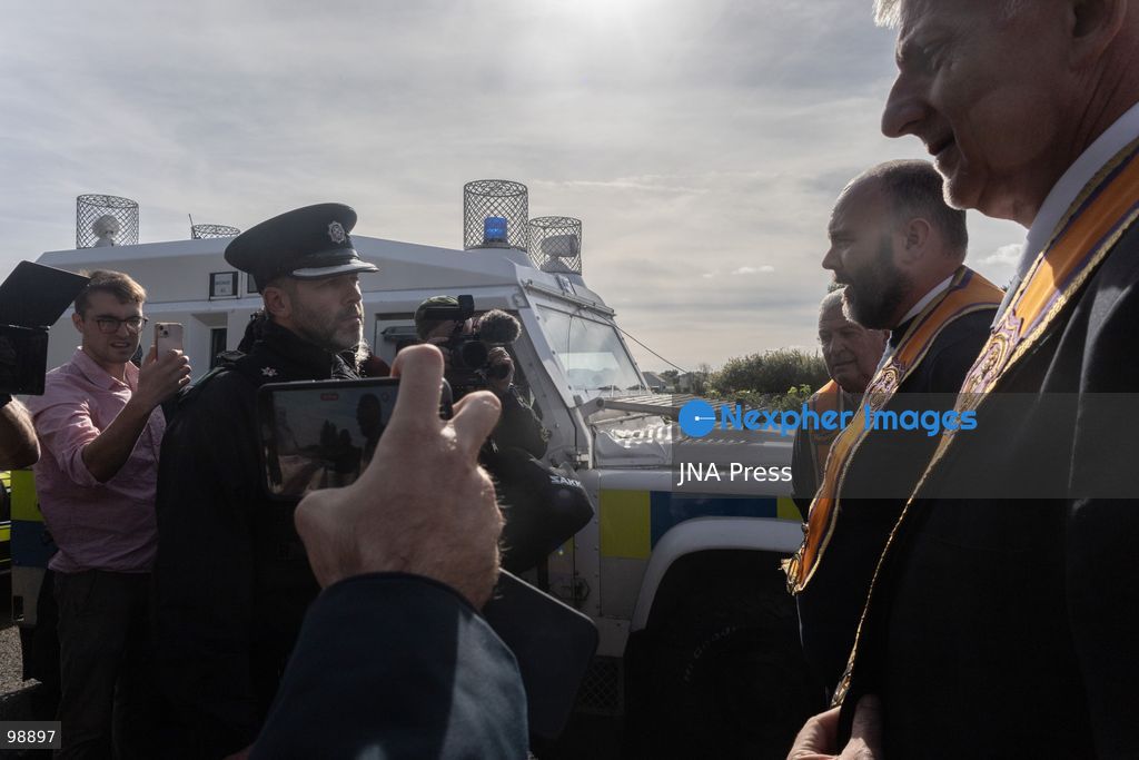 PORTADOWN, NORTHERN IRELAND, SEPTEMBER 28, 2026: Members of the Orange Order gather near Drumcree Parish Church as a standoff over the contentious Drumcree parade continues in Portadown. The Protestant fraternal organization had been granted conditional permission to march along the predominantly nationalist Garvaghy Road for the first time in nearly three decades, but the route was blocked by thousands of protesters and police prevented the parade from proceeding amid public safety concerns. On Monday, residents continued gathering on Garvaghy Road while Orange Order members remained near Drumcree Church as discussions continued with police and officials over the dispute. Photo by Nadia Caimi / JNA Press. (Photo by Nadia Caimi/JNA Press via Nexpher Images)