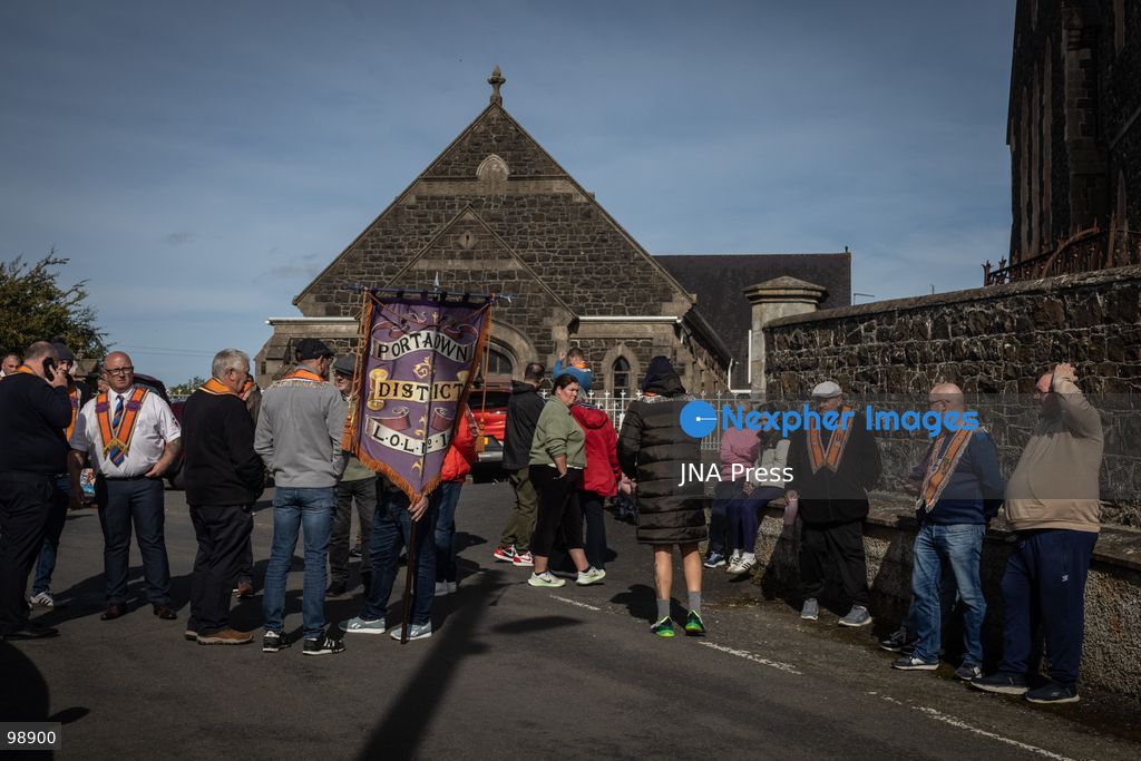 PORTADOWN, NORTHERN IRELAND, SEPTEMBER 28, 2026: Members of the Orange Order gather near Drumcree Parish Church as a standoff over the contentious Drumcree parade continues in Portadown. The Protestant fraternal organization had been granted conditional permission to march along the predominantly nationalist Garvaghy Road for the first time in nearly three decades, but the route was blocked by thousands of protesters and police prevented the parade from proceeding amid public safety concerns. On Monday, residents continued gathering on Garvaghy Road while Orange Order members remained near Drumcree Church as discussions continued with police and officials over the dispute. Photo by Nadia Caimi / JNA Press. (Photo by Nadia Caimi/JNA Press via Nexpher Images)