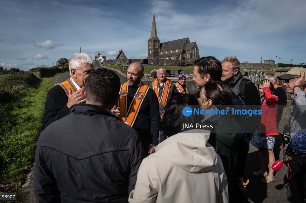 PORTADOWN, NORTHERN IRELAND, SEPTEMBER 28, 2026: Members of the Orange Order gather near Drumcree Parish Church as a standoff over the contentious Drumcree parade continues in Portadown. The Protestant fraternal organization had been granted conditional permission to march along the predominantly nationalist Garvaghy Road for the first time in nearly three decades, but the route was blocked by thousands of protesters and police prevented the parade from proceeding amid public safety concerns. On Monday, residents continued gathering on Garvaghy Road while Orange Order members remained near Drumcree Church as discussions continued with police and officials over the dispute. Photo by Nadia Caimi / JNA Press. (Photo by Nadia Caimi/JNA Press via Nexpher Images)