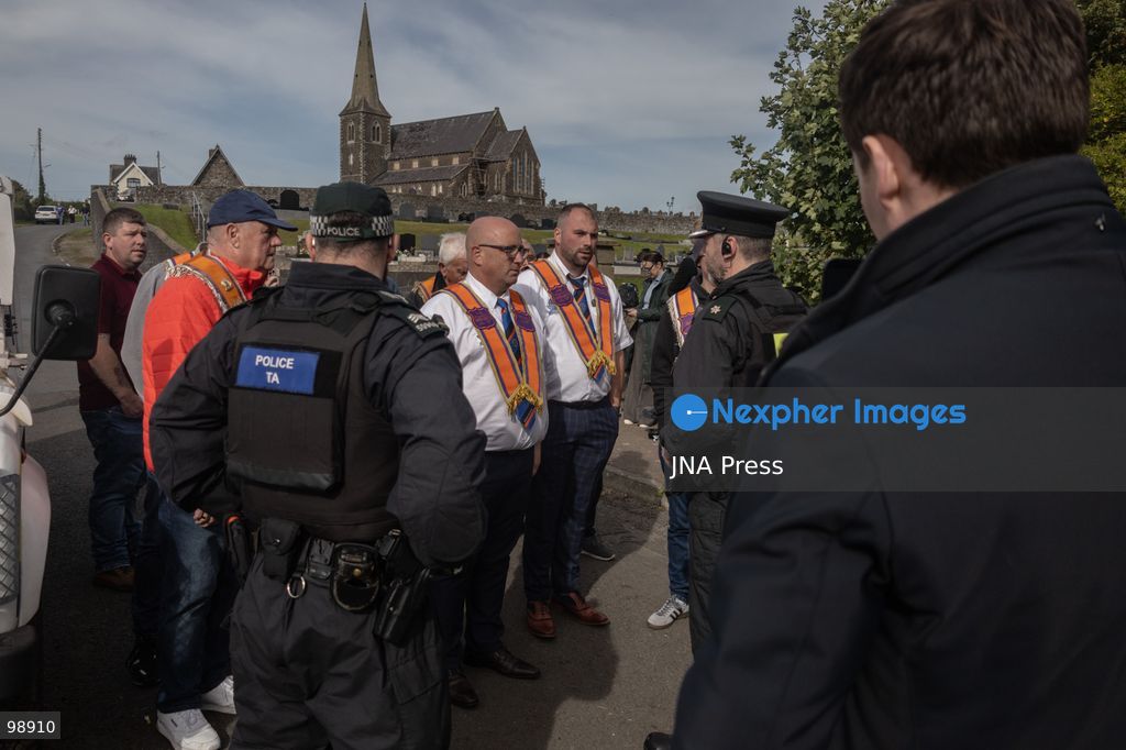 PORTADOWN, NORTHERN IRELAND, SEPTEMBER 28, 2026: Members of the Orange Order gather near Drumcree Parish Church as a standoff over the contentious Drumcree parade continues in Portadown. The Protestant fraternal organization had been granted conditional permission to march along the predominantly nationalist Garvaghy Road for the first time in nearly three decades, but the route was blocked by thousands of protesters and police prevented the parade from proceeding amid public safety concerns. On Monday, residents continued gathering on Garvaghy Road while Orange Order members remained near Drumcree Church as discussions continued with police and officials over the dispute. Photo by Nadia Caimi / JNA Press. (Photo by Nadia Caimi/JNA Press via Nexpher Images)
