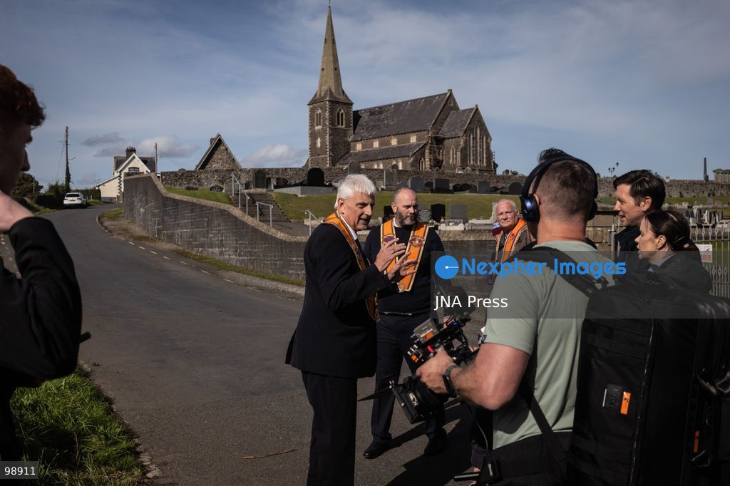 PORTADOWN, NORTHERN IRELAND, SEPTEMBER 28, 2026: Members of the Orange Order gather near Drumcree Parish Church as a standoff over the contentious Drumcree parade continues in Portadown. The Protestant fraternal organization had been granted conditional permission to march along the predominantly nationalist Garvaghy Road for the first time in nearly three decades, but the route was blocked by thousands of protesters and police prevented the parade from proceeding amid public safety concerns. On Monday, residents continued gathering on Garvaghy Road while Orange Order members remained near Drumcree Church as discussions continued with police and officials over the dispute. Photo by Nadia Caimi / JNA Press. (Photo by Nadia Caimi/JNA Press via Nexpher Images)