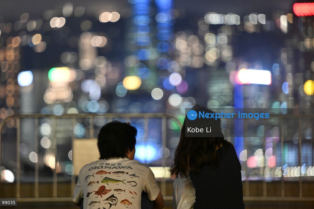 People view the illuminated skyline of Hong Kong at night from a waterfront promenade on September 29, 2026 in Hong Kong. (Photo by Kobe Li/Nexpher Images)
