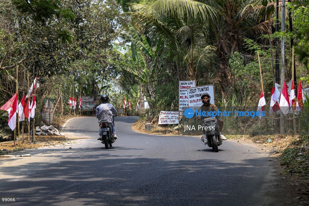MAGELANG, CENTRAL JAVA, INDONESIA, SEPTEMBER 29, 2026: Indonesian flags fly at half-mast along a road in Sambeng Village, Borobudur, as residents stage a symbolic protest against sand mining activities in the Progo River. Local residents say the mining threatens water sources and could damage the surrounding environment. Photo by Ilham Nur Arifin / JNA Press. (Photo by Ilham Nur Arifin/JNA Press via Nexpher Images)