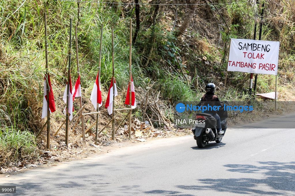 MAGELANG, CENTRAL JAVA, INDONESIA, SEPTEMBER 29, 2026: Indonesian flags fly at half-mast along a road in Sambeng Village, Borobudur, as residents stage a symbolic protest against sand mining activities in the Progo River. Local residents say the mining threatens water sources and could damage the surrounding environment. Photo by Ilham Nur Arifin / JNA Press. (Photo by Ilham Nur Arifin/JNA Press via Nexpher Images)