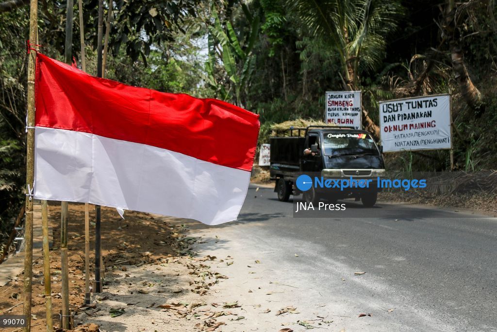 MAGELANG, CENTRAL JAVA, INDONESIA, SEPTEMBER 29, 2026: Indonesian flags fly at half-mast along a road in Sambeng Village, Borobudur, as residents stage a symbolic protest against sand mining activities in the Progo River. Local residents say the mining threatens water sources and could damage the surrounding environment. Photo by Ilham Nur Arifin / JNA Press. (Photo by Ilham Nur Arifin/JNA Press via Nexpher Images)