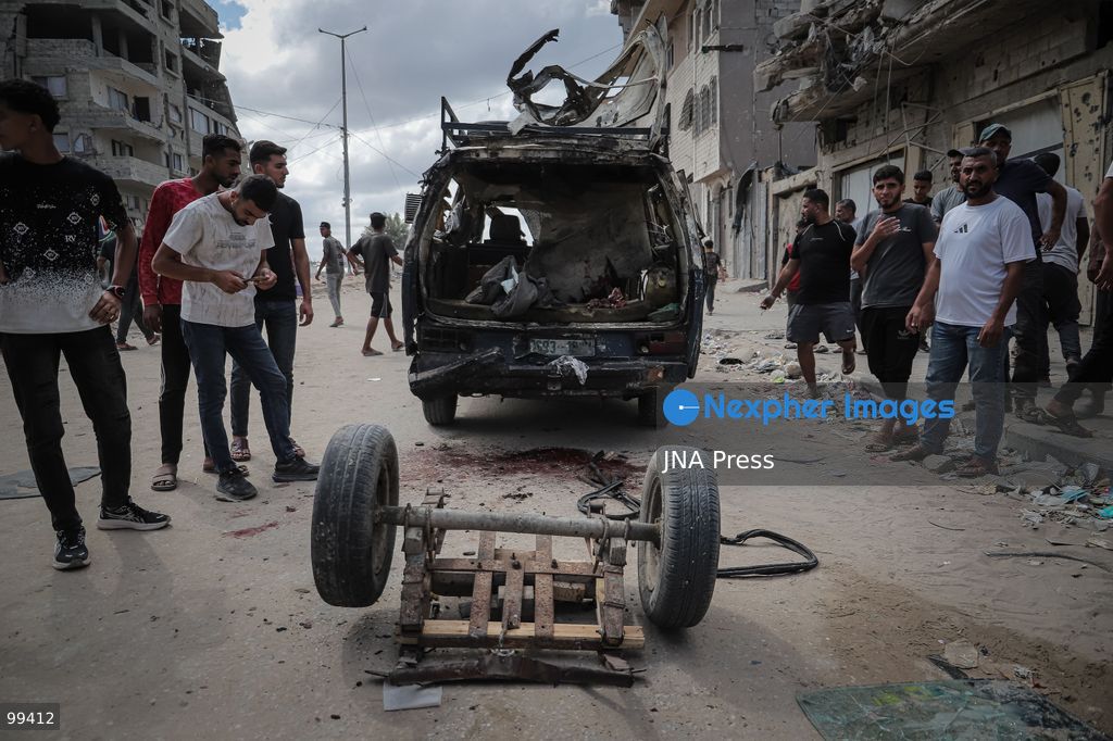 GAZA CITY, GAZA STRIP, SEPTEMBER 30, 2026: Palestinians gather at the scene after an Israeli airstrike targeted a vehicle in the Tel al-Hawa neighborhood of Gaza City. Five Palestinians were killed and 13 others injured in the strike, according to the Palestinian Red Crescent Society, which said its crews transported the dead to Al-Shifa Hospital and the wounded to Al-Quds Hospital. The Israeli military had not immediately commented on the strike. Photo by Mohammed M. Skaik / JNA Press. (Photo by Mohammed M Skaik/JNA Press via Nexpher Images)