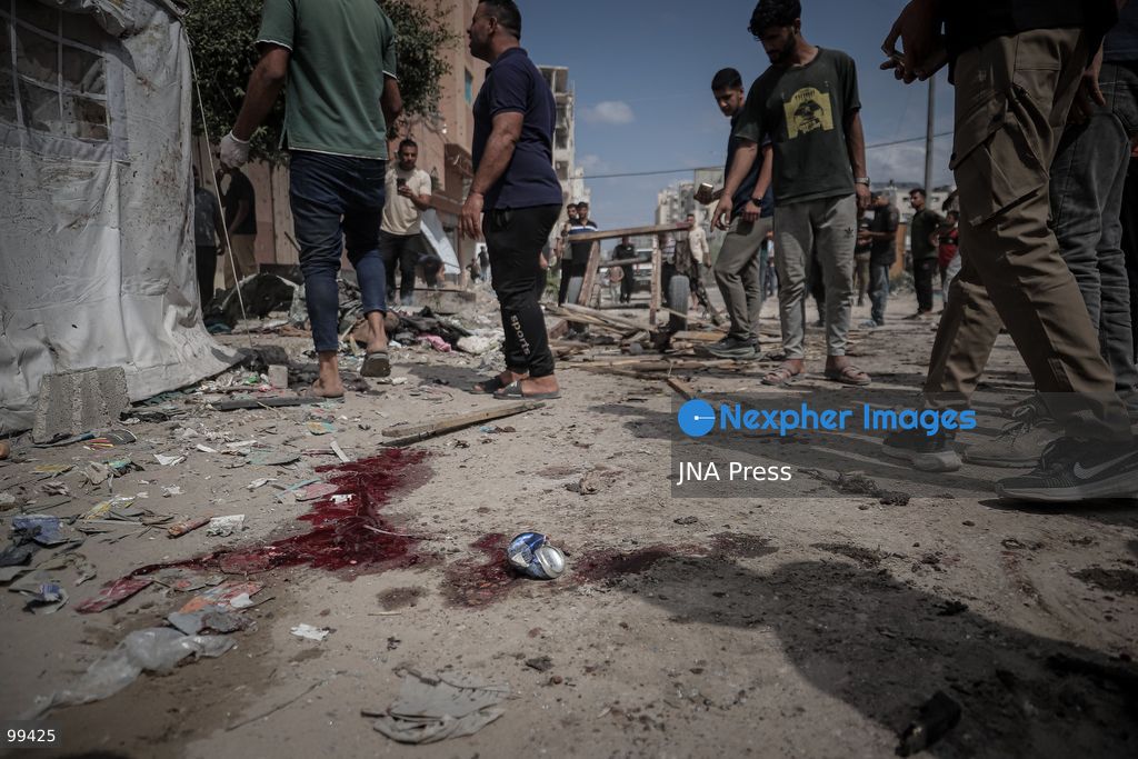 GAZA CITY, GAZA STRIP, SEPTEMBER 30, 2026: Palestinians gather at the scene after an Israeli airstrike targeted a vehicle in the Tel al-Hawa neighborhood of Gaza City. Five Palestinians were killed and 13 others injured in the strike, according to the Palestinian Red Crescent Society, which said its crews transported the dead to Al-Shifa Hospital and the wounded to Al-Quds Hospital. The Israeli military had not immediately commented on the strike. Photo by Mohammed M. Skaik / JNA Press. (Photo by Mohammed M Skaik/JNA Press via Nexpher Images)