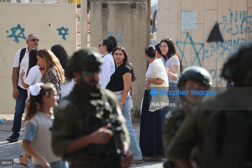 HEBRON, OCCUPIED WEST BANK, SEPTEMBER 30, 2026: Israeli settlers walk through Hebron's Old City under the protection of Israeli forces during celebrations for the Jewish holiday of Sukkot. Israeli forces maintained heightened security measures and movement restrictions around the Old City and the Ibrahimi Mosque during the holiday period. Photo by Mosab Shawer / JNA Press. (Photo by Mosab shawer/JNA Press via Nexpher Images)