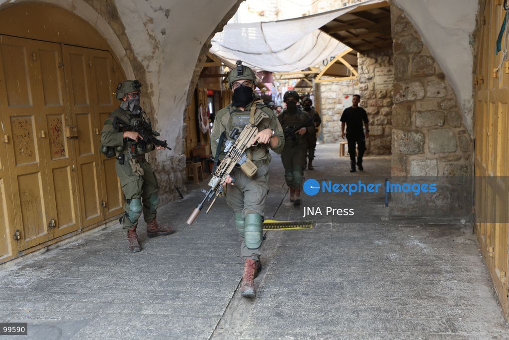 HEBRON, OCCUPIED WEST BANK, SEPTEMBER 30, 2026: Israeli settlers walk through Hebron's Old City under the protection of Israeli forces during celebrations for the Jewish holiday of Sukkot. Israeli forces maintained heightened security measures and movement restrictions around the Old City and the Ibrahimi Mosque during the holiday period. Photo by Mosab Shawer / JNA Press. (Photo by Mosab shawer/JNA Press via Nexpher Images)