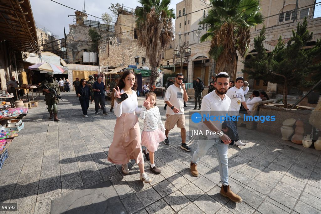 HEBRON, OCCUPIED WEST BANK, SEPTEMBER 30, 2026: Israeli settlers walk through Hebron's Old City under the protection of Israeli forces during celebrations for the Jewish holiday of Sukkot. Israeli forces maintained heightened security measures and movement restrictions around the Old City and the Ibrahimi Mosque during the holiday period. Photo by Mosab Shawer / JNA Press. (Photo by Mosab shawer/JNA Press via Nexpher Images)