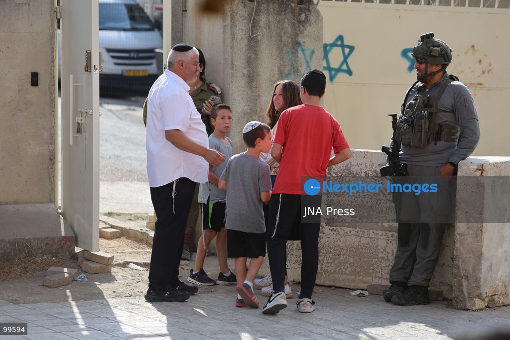 HEBRON, OCCUPIED WEST BANK, SEPTEMBER 30, 2026: Israeli settlers walk through Hebron's Old City under the protection of Israeli forces during celebrations for the Jewish holiday of Sukkot. Israeli forces maintained heightened security measures and movement restrictions around the Old City and the Ibrahimi Mosque during the holiday period. Photo by Mosab Shawer / JNA Press. (Photo by Mosab shawer/JNA Press via Nexpher Images)