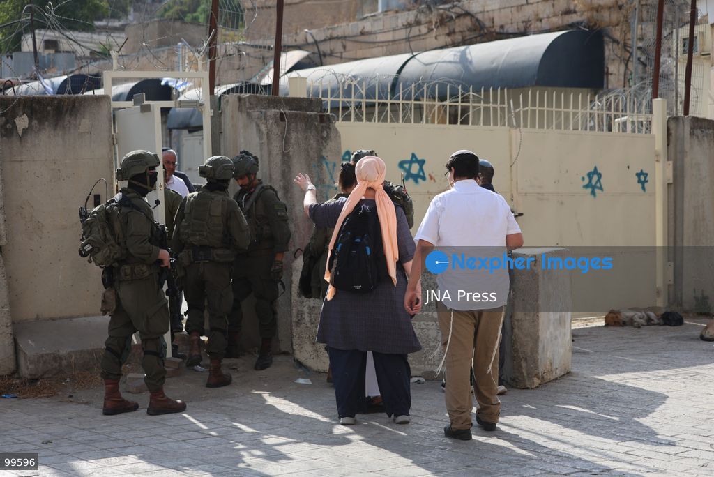 HEBRON, OCCUPIED WEST BANK, SEPTEMBER 30, 2026: Israeli settlers walk through Hebron's Old City under the protection of Israeli forces during celebrations for the Jewish holiday of Sukkot. Israeli forces maintained heightened security measures and movement restrictions around the Old City and the Ibrahimi Mosque during the holiday period. Photo by Mosab Shawer / JNA Press. (Photo by Mosab shawer/JNA Press via Nexpher Images)
