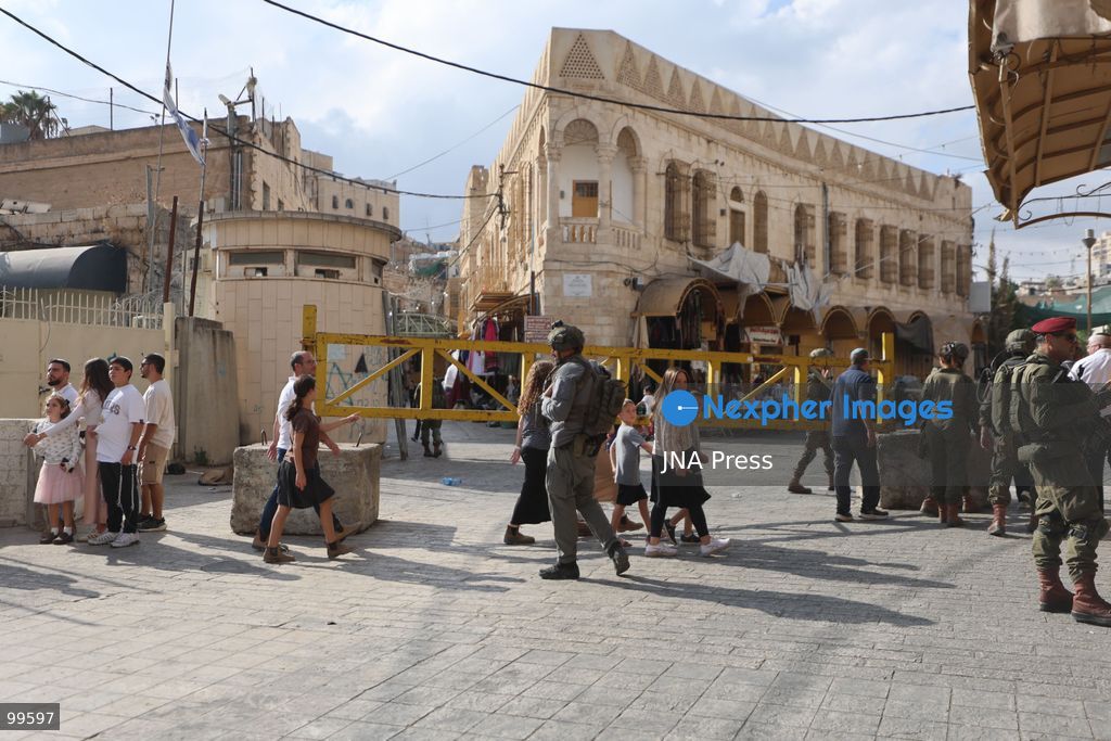 HEBRON, OCCUPIED WEST BANK, SEPTEMBER 30, 2026: Israeli settlers walk through Hebron's Old City under the protection of Israeli forces during celebrations for the Jewish holiday of Sukkot. Israeli forces maintained heightened security measures and movement restrictions around the Old City and the Ibrahimi Mosque during the holiday period. Photo by Mosab Shawer / JNA Press. (Photo by Mosab shawer/JNA Press via Nexpher Images)