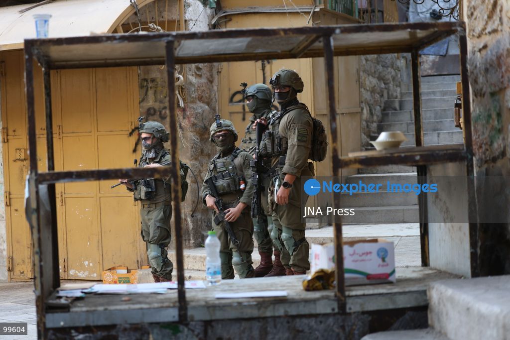 HEBRON, OCCUPIED WEST BANK, SEPTEMBER 30, 2026: Israeli settlers walk through Hebron's Old City under the protection of Israeli forces during celebrations for the Jewish holiday of Sukkot. Israeli forces maintained heightened security measures and movement restrictions around the Old City and the Ibrahimi Mosque during the holiday period. Photo by Mosab Shawer / JNA Press. (Photo by Mosab shawer/JNA Press via Nexpher Images)