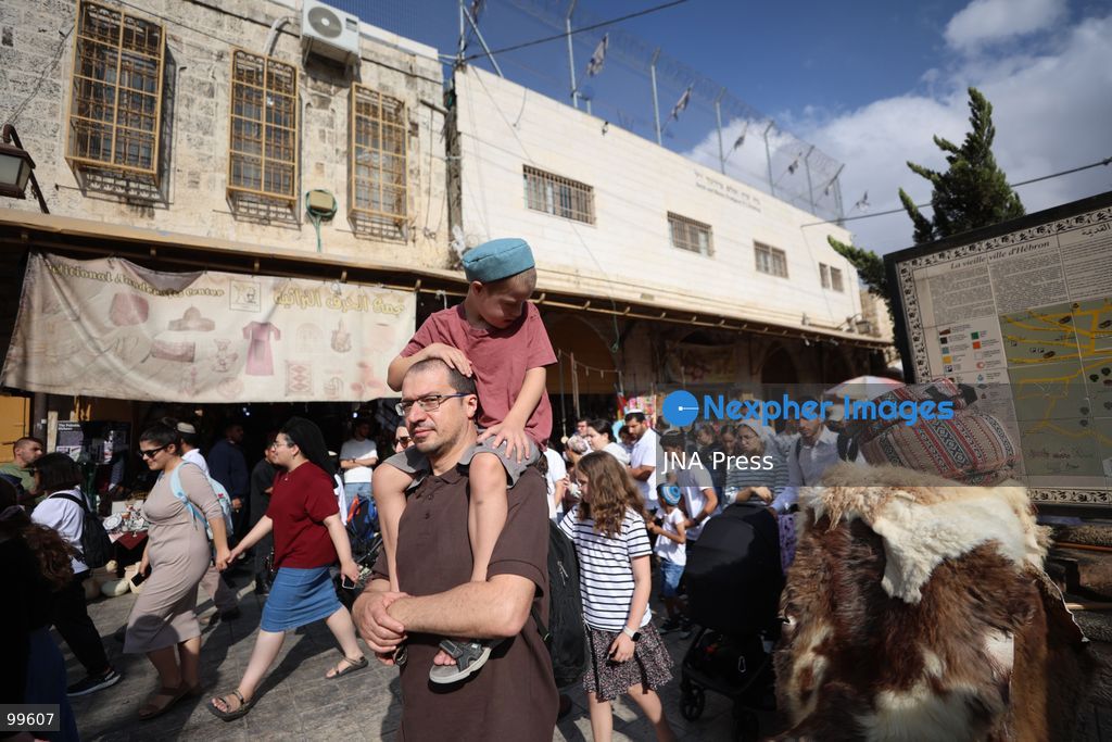 HEBRON, OCCUPIED WEST BANK, SEPTEMBER 30, 2026: Israeli settlers walk through Hebron's Old City under the protection of Israeli forces during celebrations for the Jewish holiday of Sukkot. Israeli forces maintained heightened security measures and movement restrictions around the Old City and the Ibrahimi Mosque during the holiday period. Photo by Mosab Shawer / JNA Press. (Photo by Mosab shawer/JNA Press via Nexpher Images)