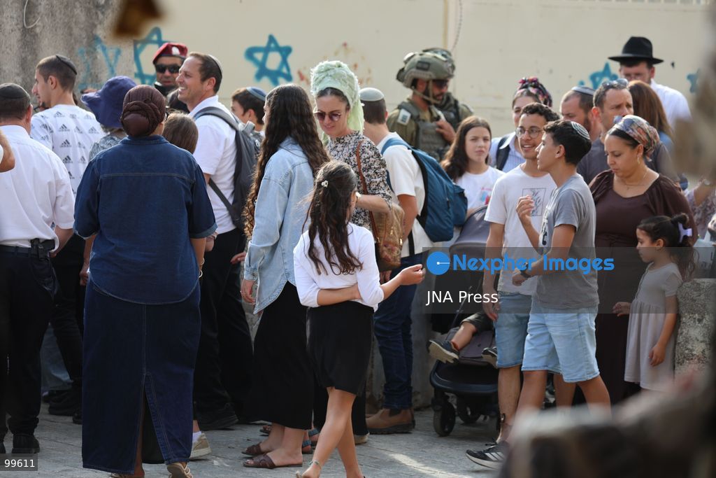 HEBRON, OCCUPIED WEST BANK, SEPTEMBER 30, 2026: Israeli settlers walk through Hebron's Old City under the protection of Israeli forces during celebrations for the Jewish holiday of Sukkot. Israeli forces maintained heightened security measures and movement restrictions around the Old City and the Ibrahimi Mosque during the holiday period. Photo by Mosab Shawer / JNA Press. (Photo by Mosab shawer/JNA Press via Nexpher Images)