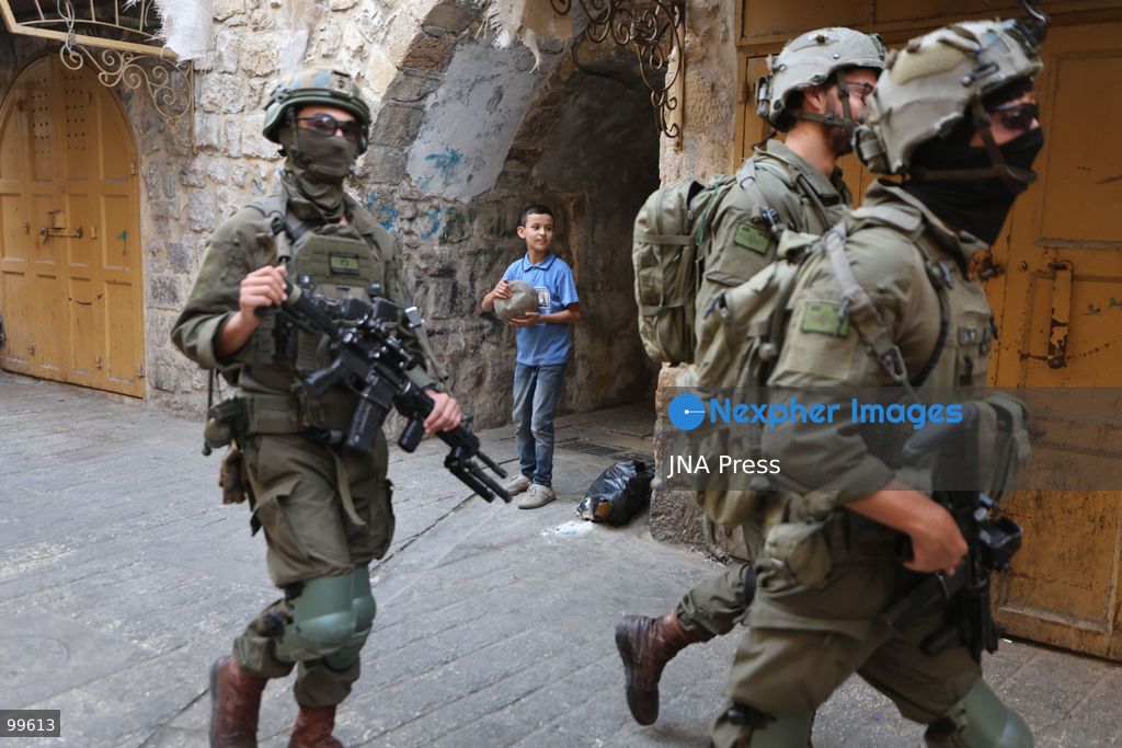 HEBRON, OCCUPIED WEST BANK, SEPTEMBER 30, 2026: Israeli settlers walk through Hebron's Old City under the protection of Israeli forces during celebrations for the Jewish holiday of Sukkot. Israeli forces maintained heightened security measures and movement restrictions around the Old City and the Ibrahimi Mosque during the holiday period. Photo by Mosab Shawer / JNA Press. (Photo by Mosab shawer/JNA Press via Nexpher Images)