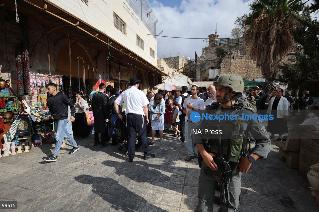 HEBRON, OCCUPIED WEST BANK, SEPTEMBER 30, 2026: Israeli settlers walk through Hebron's Old City under the protection of Israeli forces during celebrations for the Jewish holiday of Sukkot. Israeli forces maintained heightened security measures and movement restrictions around the Old City and the Ibrahimi Mosque during the holiday period. Photo by Mosab Shawer / JNA Press. (Photo by Mosab shawer/JNA Press via Nexpher Images)