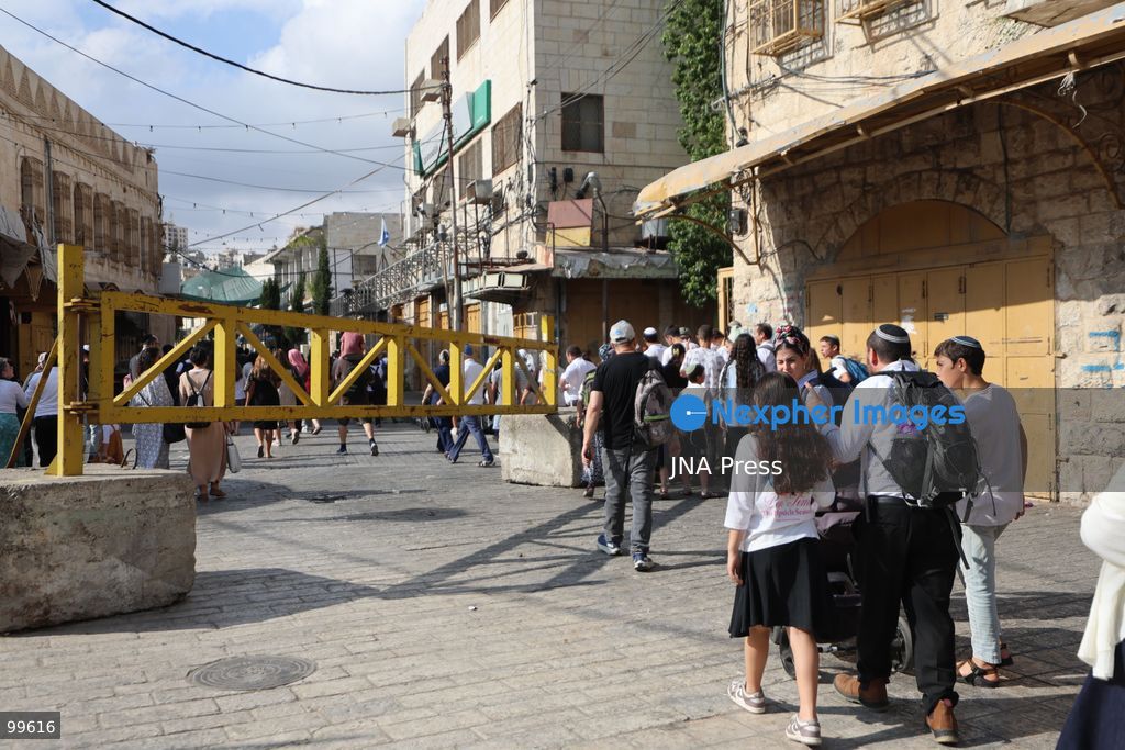 HEBRON, OCCUPIED WEST BANK, SEPTEMBER 30, 2026: Israeli settlers walk through Hebron's Old City under the protection of Israeli forces during celebrations for the Jewish holiday of Sukkot. Israeli forces maintained heightened security measures and movement restrictions around the Old City and the Ibrahimi Mosque during the holiday period. Photo by Mosab Shawer / JNA Press. (Photo by Mosab shawer/JNA Press via Nexpher Images)