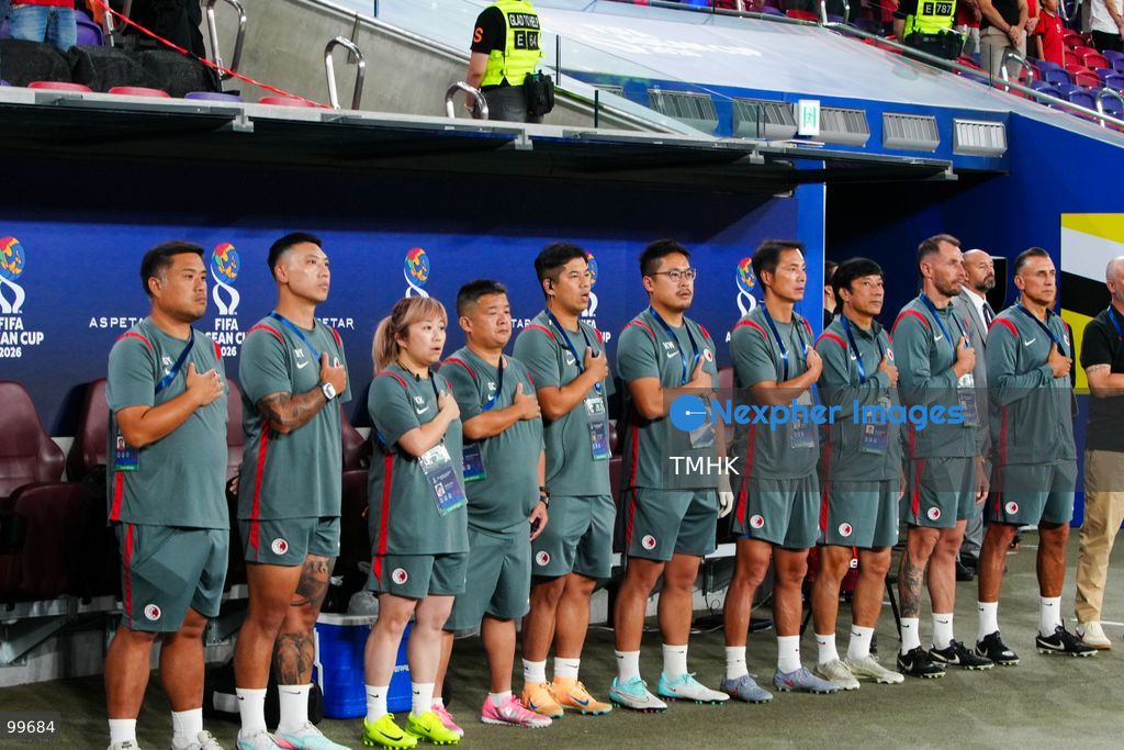 Members of the Hong Kong, China coaching staff stand and sing the national anthem of China, the "March of the Volunteers", on the touchline ahead of their FIFA ASEAN Cup Tier 2 match against Brunei at Kai Tak Stadium on September 30, 2026 in Hong Kong. (Photo by Zulu Lo/TMHK via Nexpher Images)