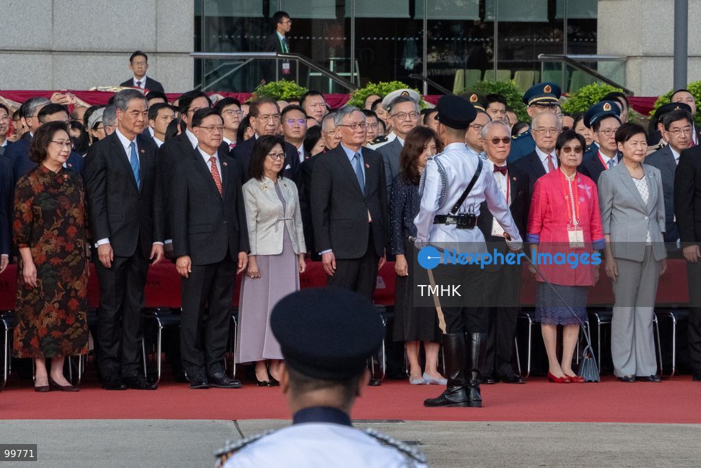The commander of the disciplined services guard of honour marches forward and reports to Hong Kong Chief Executive John Lee Ka-chiu that the flag-raising parade is ready to commence, prompting Lee to give the order to proceed at Golden Bauhinia Square on October 1, 2026 in Hong Kong. (Photo by Kevin Li/TMHK via Nexpher Images)