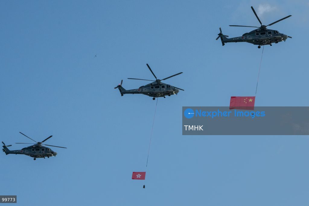 Two Government Flying Service (GFS) helicopters carrying the national flag of China and the Hong Kong regional flag fly past above Golden Bauhinia Square and Victoria Harbour during the 77th National Day celebration on October 1, 2026 in Hong Kong. (Photo by Kevin Li/TMHK via Nexpher Images)
