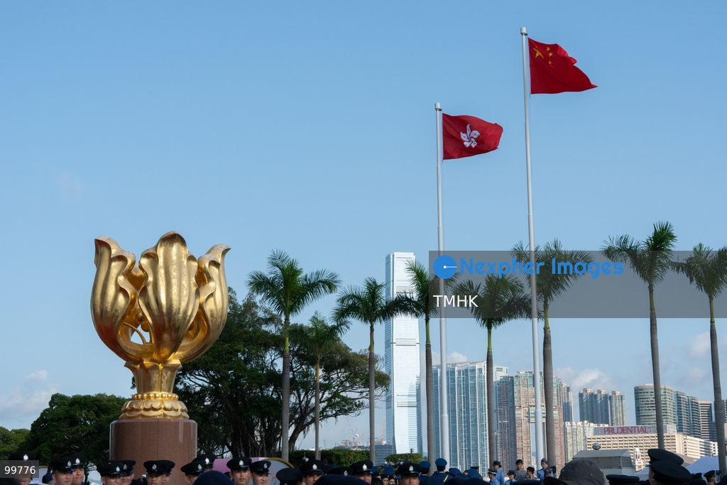 A general view shows the national flag of China and the Hong Kong regional flag fluttering atop flagpoles above the Forever Blooming Bauhinia Sculpture at Golden Bauhinia Square following the 77th National Day flag-raising ceremony on October 1, 2026 in Hong Kong. (Photo by Kevin Li/TMHK via Nexpher Images)