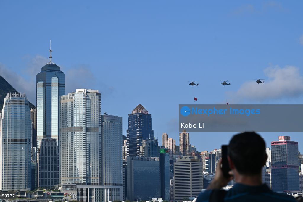 Helicopters carrying the national flag of China and regional flag of Hong Kong fly pass the flag raising ceremony on October 1, 2026 in Hong Kong. Today is the China's National Day. (Photo by Kobe Li/Nexpher Images)