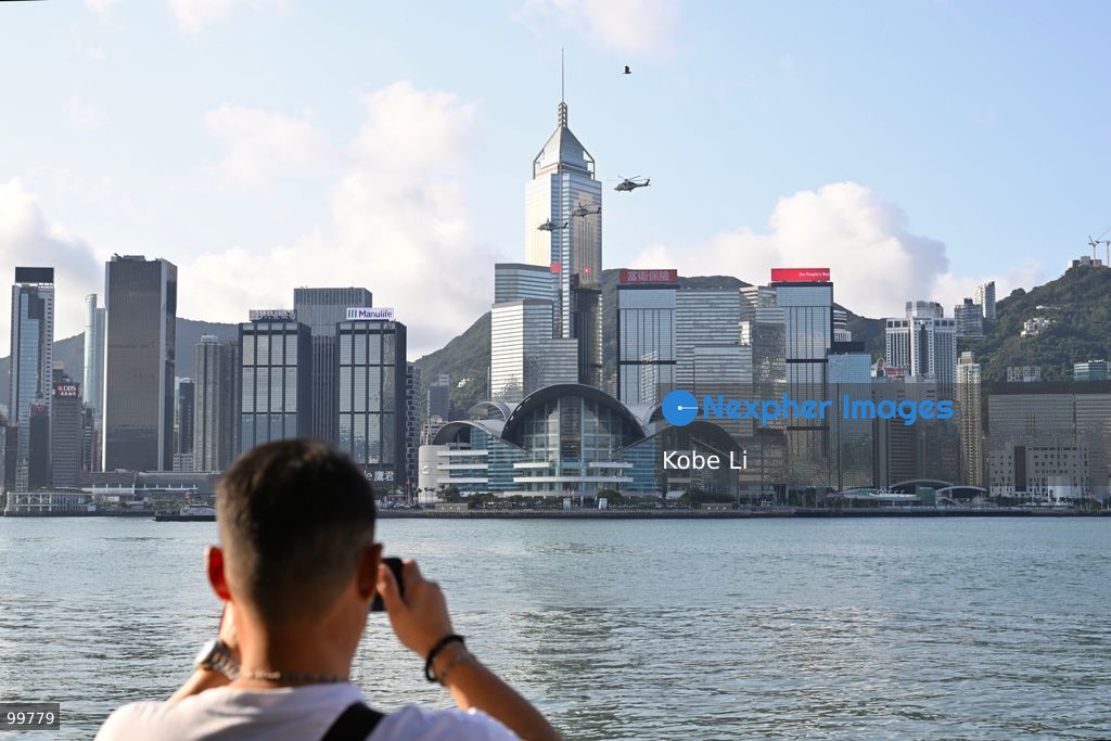 Helicopters carrying the national flag of China and regional flag of Hong Kong fly pass the flag raising ceremony on October 1, 2026 in Hong Kong. Today is the China's National Day. (Photo by Kobe Li/Nexpher Images)