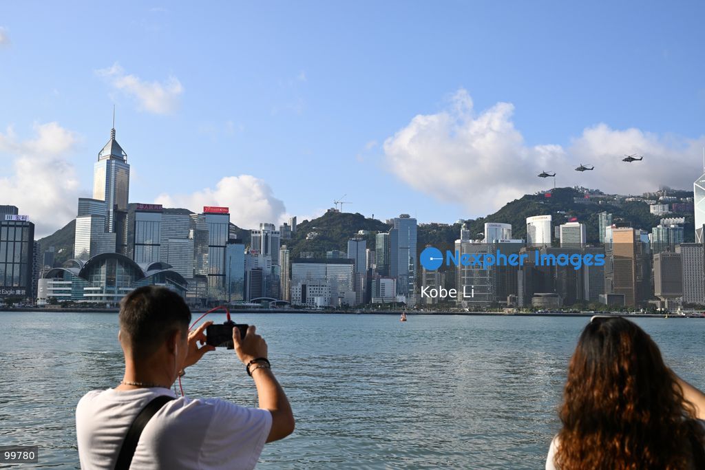 Helicopters carrying the national flag of China and regional flag of Hong Kong fly pass the flag raising ceremony on October 1, 2026 in Hong Kong. Today is the China's National Day. (Photo by Kobe Li/Nexpher Images)