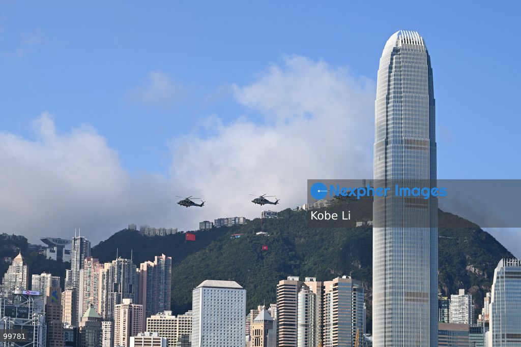 Helicopters carrying the national flag of China and regional flag of Hong Kong fly pass the flag raising ceremony on October 1, 2026 in Hong Kong. Today is the China's National Day. (Photo by Kobe Li/Nexpher Images)