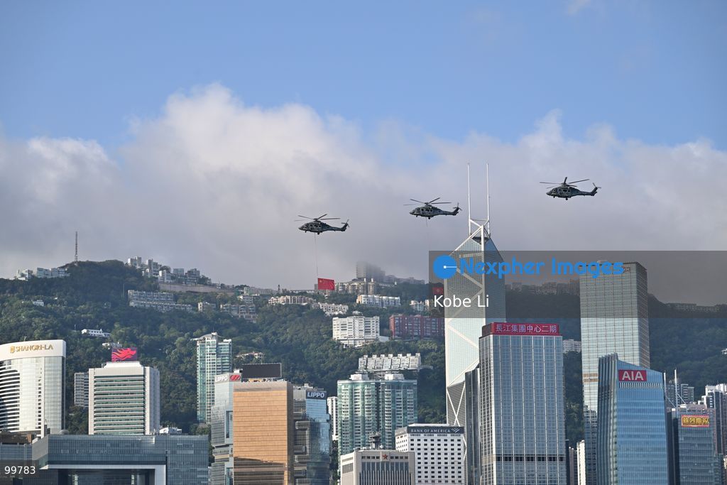 Helicopters carrying the national flag of China and regional flag of Hong Kong fly pass the flag raising ceremony on October 1, 2026 in Hong Kong. Today is the China's National Day. (Photo by Kobe Li/Nexpher Images)