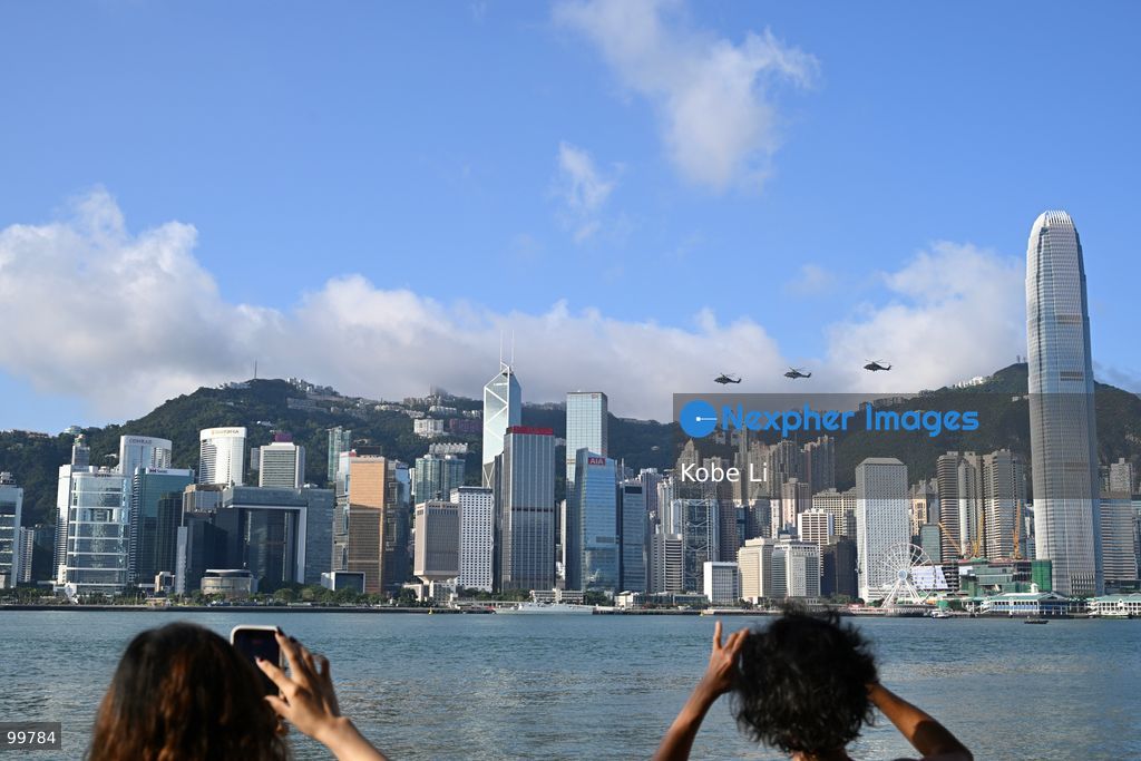Helicopters carrying the national flag of China and regional flag of Hong Kong fly pass the flag raising ceremony on October 1, 2026 in Hong Kong. Today is the China's National Day. (Photo by Kobe Li/Nexpher Images)
