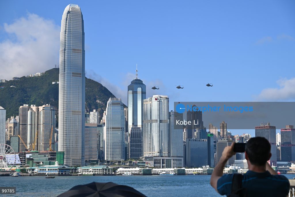 Helicopters carrying the national flag of China and regional flag of Hong Kong fly pass the flag raising ceremony on October 1, 2026 in Hong Kong. Today is the China's National Day. (Photo by Kobe Li/Nexpher Images)