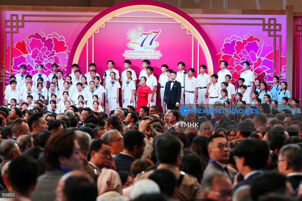 Student choir members from Yuen Long Government Secondary School and New Territories Heung Yee Kuk Yuen Long District Secondary School lead attendees in singing the national anthem of China during the National Day reception at the Hong Kong Convention and Exhibition Centre on October 1, 2026 in Hong Kong. (Photo by Zulu Lo/TMHK via Nexpher Images)