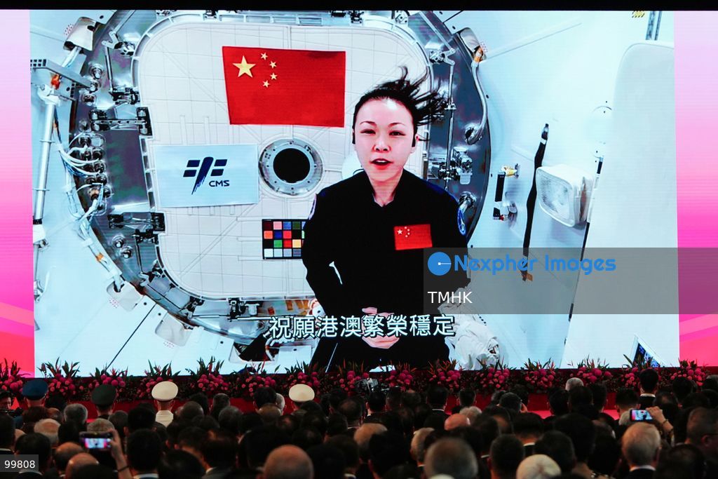 A giant LED screen displays a pre-recorded video address from Hong Kong's first payload specialist, Lai Ka-ying, speaking from aboard China's Tiangong space station during the Shenzhou-23 mission, as she delivers National Day congratulations and wishes prosperity and stability for Hong Kong and Macao during the reception at the Hong Kong Convention and Exhibition Centre on October 1, 2026 in Hong Kong. (Photo by Zulu Lo/TMHK via Nexpher Images)
