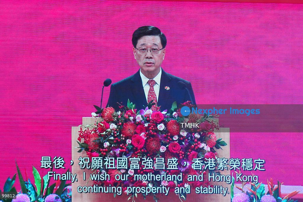 The main stage LED screen displays a close-up image of Hong Kong Chief Executive John Lee Ka-chiu accompanied by on-screen subtitles reading "Wishing our country prosperity and strength, and Hong Kong lasting prosperity and stability" during his speech at the 77th National Day reception on October 1, 2026 in Hong Kong. (Photo by Zulu Lo/TMHK via Nexpher Images)