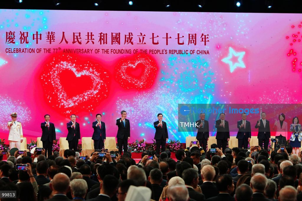 Hong Kong Chief Executive John Lee Ka-chiu, Vice Chairman of the National Committee of the CPPCC Leung Chun-ying, Chief Justice of the Court of Final Appeal Andrew Cheung Kui-nung, Chief Secretary for Administration Eric Chan Kwok-ki, Financial Secretary Paul Chan Mo-po, Secretary for Justice Paul Lam Ting-kwok, Legislative Council President Starry Lee Wai-king, Executive Council Convenor Regina Ip Lau Suk-yee, Director of the Liaison Office of the Central People's Government Zhou Ji, and other representatives of central government agencies in Hong Kong raise a toast together on stage during the official reception celebrating the 77th anniversary of the founding of the People's Republic of China in the Grand Hall of the Hong Kong Convention and Exhibition Centre on October 1, 2026 in Hong Kong. (Photo by Zulu Lo/TMHK via Nexpher Images)