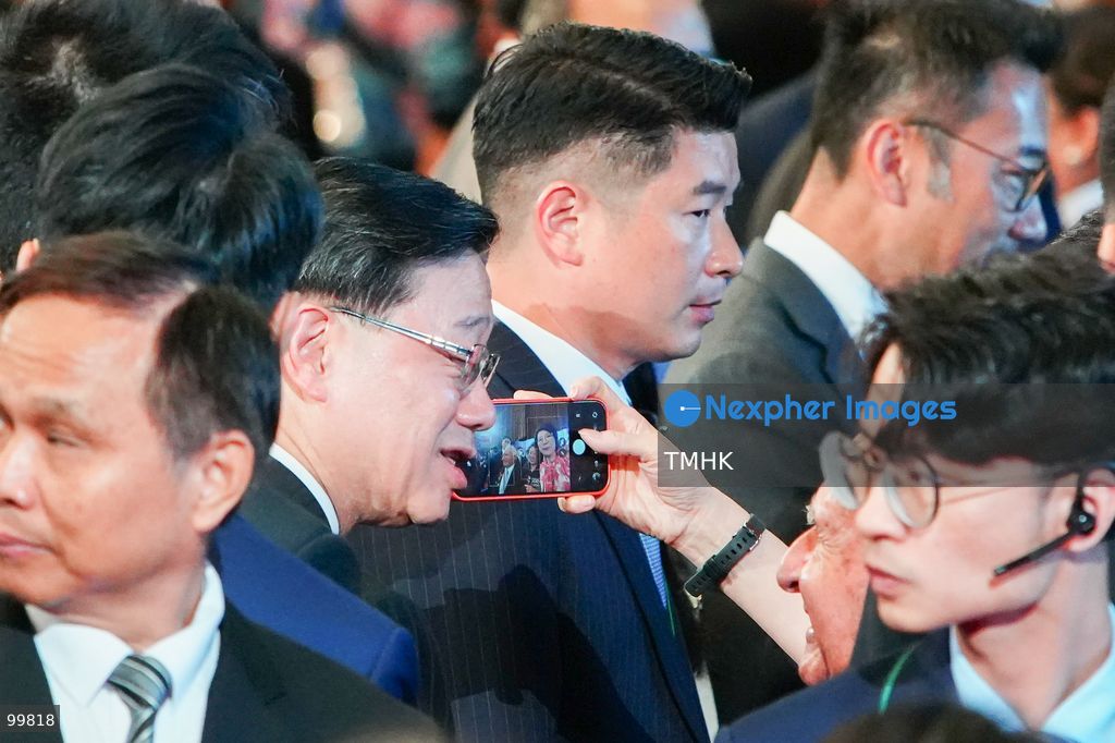 Hong Kong Chief Executive John Lee Ka-chiu takes selfies and interacts warmly with attendees in the Grand Hall as he departs the 77th National Day reception at the Hong Kong Convention and Exhibition Centre on October 1, 2026 in Hong Kong. (Photo by Zulu Lo/TMHK via Nexpher Images)
