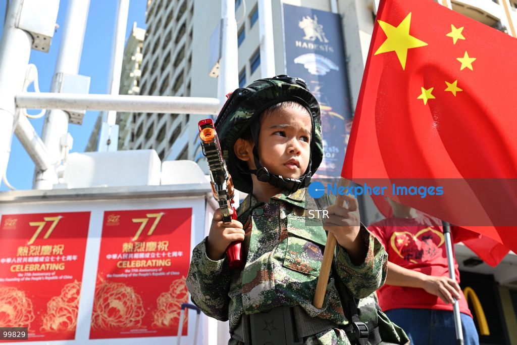 A child wearing Chinese military uniform, holding a national flag of China and a toy gun on October 1, 2026 in Hong Kong. Today is the China's National Day. (Photo by STR/Nexpher Images)